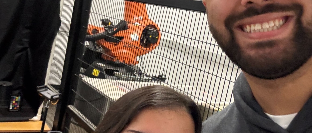 Jalissa and Sam pose by the Donald Danforth Plant Science Center robot arm.